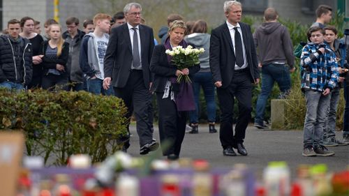 Education Minister of the German state North Rhine-Westphalia Sylvia Loehrmann, center, arrives with flowers. (AAP)