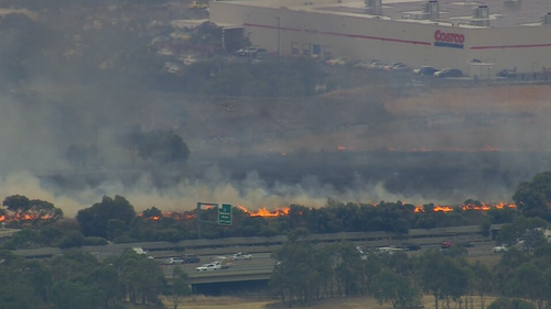 The grassfire is burning beside the Western Ring Road in Ardeer.