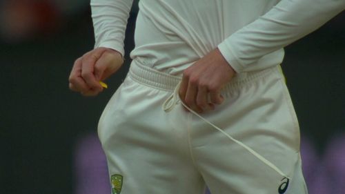 Cameron Bancroft uses a piece of sandpaper to tamper with the match ball.