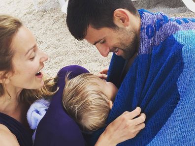 Novak and Jelena Djokovic play with their son Stefan on a beach.
