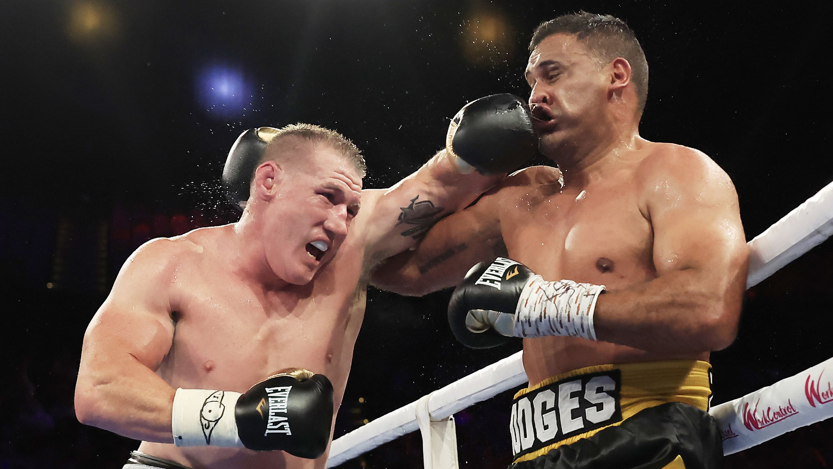 Paul Gallen throws a punch at Justin Hodges during their heavyweight fight at the Aware Super Theatre.