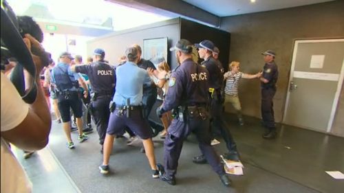 Students clashed with police as they tried to force their way into the venue. (9NEWS)