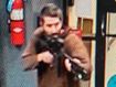 An unidentified gunman points a gun while entering Sparetime Recreation in Lewiston, Maine.