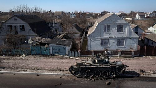 Destroyed tank sits on a street north of Kyiv