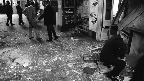Police inspect the damage in the booking office at Kings Cross station, London, after an IRA bomb exploded in 1973. (AAP)