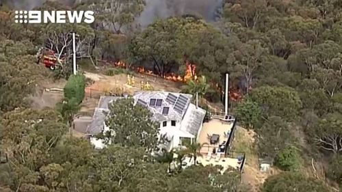 The fire which threatened a home in Beacon Hill, on the northern beaches, yesterday.