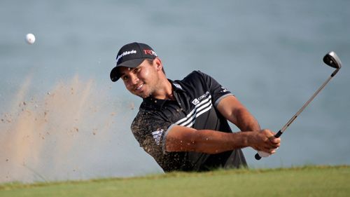 Jason Day hits out of a bunker on the 12th hole. (AAP)