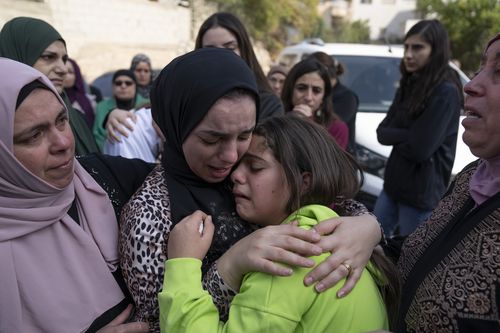 Women cry while they take the last look at the body of Ayham Shafe'e, 14, during his funeral in the West Bank city of Ramallah, Thursday, Nov. 2, 2023.  