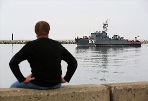 A man watches Russian minesweeper in Baltiysk, Kaliningrad (Getty)