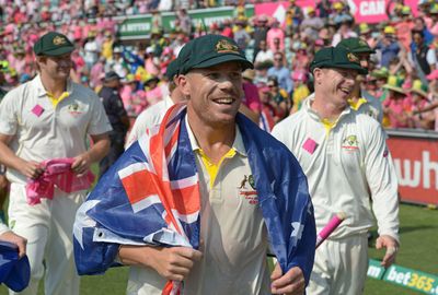 David Warner was draped in the Australian flag during a victory lap.