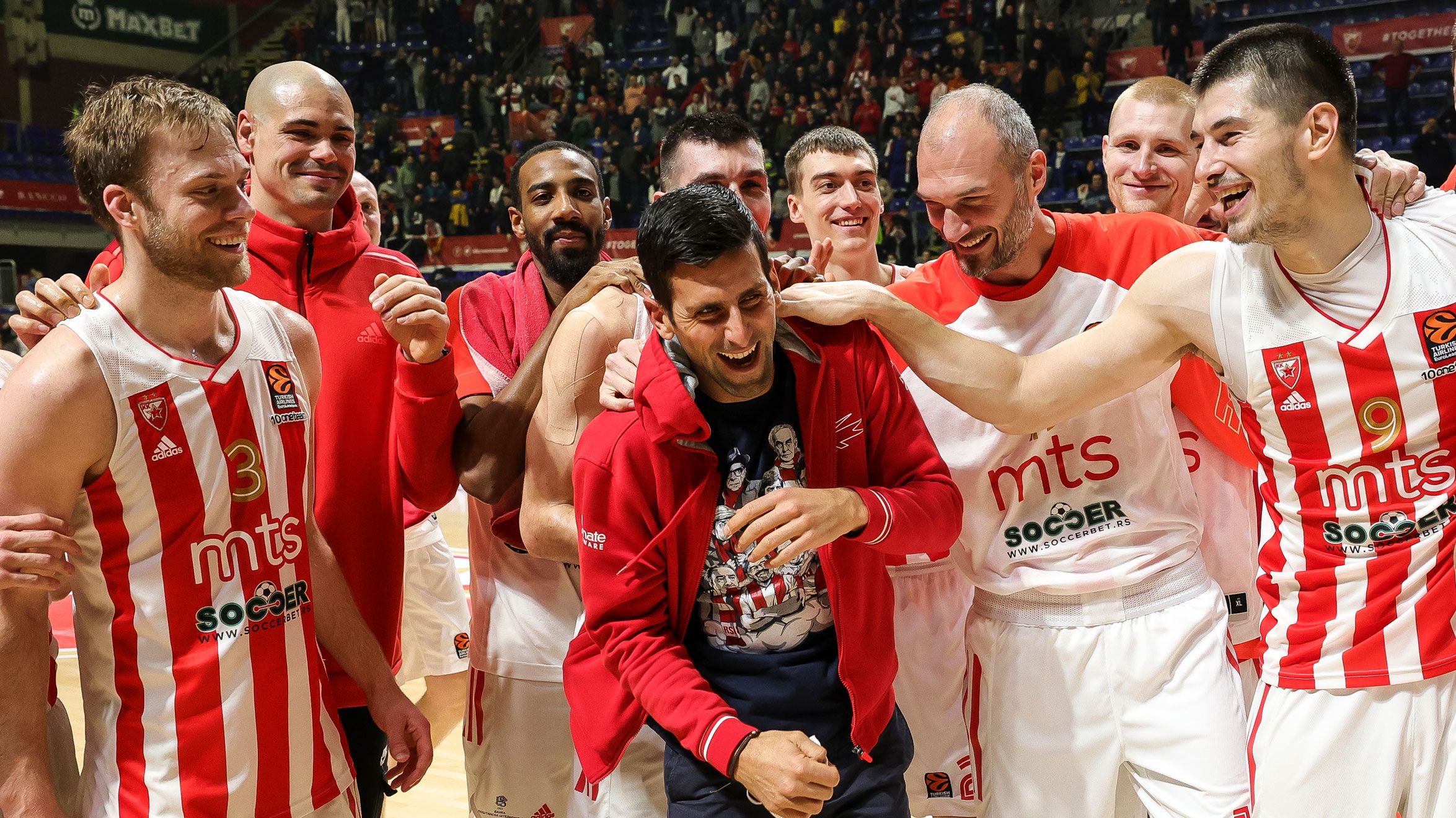 Players of Crvena Zvezda celebrate victory with Novak Djokovic after winning a EuroLeague basketball match in Belgrade.