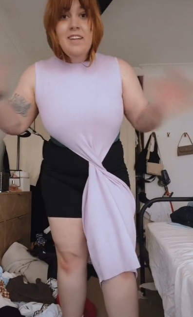 Woman tries on optical illusion dress and gets stuck while twisting it mid-way