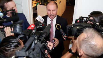 Treasurer Josh Frydenberg addresses the media during a doorstop interview in the press gallery at Parliament House in Canberra