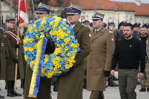 Ukrainian President Volodymyr Zelenskyy lays a wreath of flowers at the Tomb of the Unknown Soldier during his visit to Warsaw, Poland, Wednesday, April 5, 2023. 