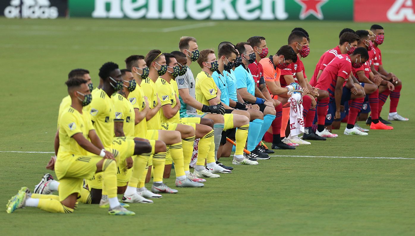 FC Dallas and Nashville kneel during the US national anthem at Toyota Stadium.
