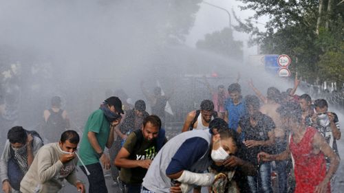 Hungarian police spray water on migrants at the 'Horgos 2' border crossing near Serbia.