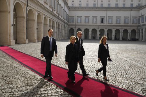 Brothers of Italy's leader Giorgia Meloni, and party member Francesco Lollobrigida, left, arrive at the Quirinale Presidential Palace for a meeting with Italian President Sergio Mattarella as part of a round of consultations with party leaders to try and form a new government, in Rome, Friday, Oct. 21, 2022.