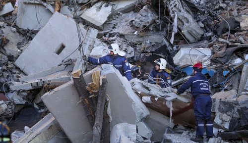 Emergency Situations employees working at the scene of a collapsed apartment building in Magnitogorsk