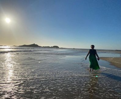 Nikki Gemmell walking in the water at the beach