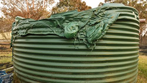 A water container on a property in Tingha has melted from the high heat of the blaze.