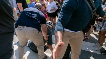 Joe Biden helped up by Secret Service agents after falling off his bike