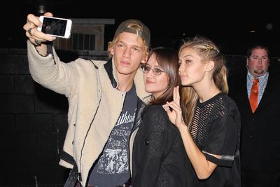 Cody Simpson and Gig Hadid enjoyed a selfie moment with a fellow partygoer.