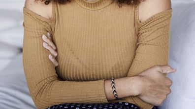 Woman sitting down with arms crossed