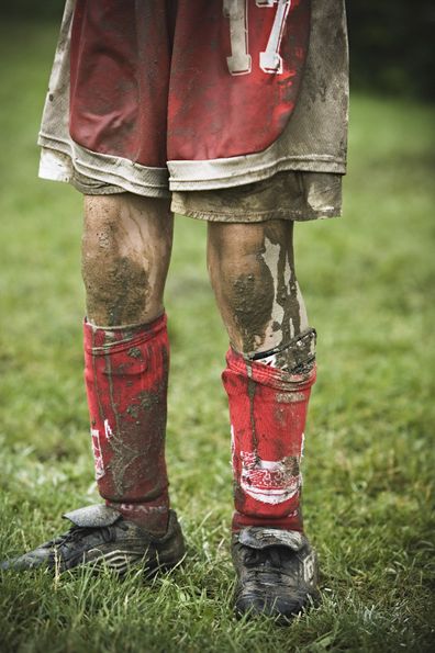 Child mud on his legs socks and boots following game.