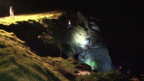 Police rescue teams scale the rocks. (9NEWS)