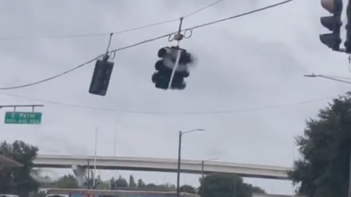 A large traffic light was ripped from suspension by Hurricane Ian's powerful winds.