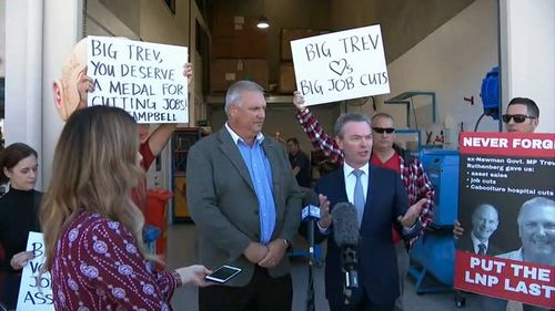 Defence Industry Minister Christopher Pyne had to battle protesters in the seat of Longman today during a media conference. Picture: 9NEWS.