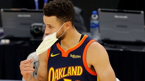 Mask use is mandatory in California with very little exceptions. In this photo, basketballer Steph Curry removes his mask before a game.