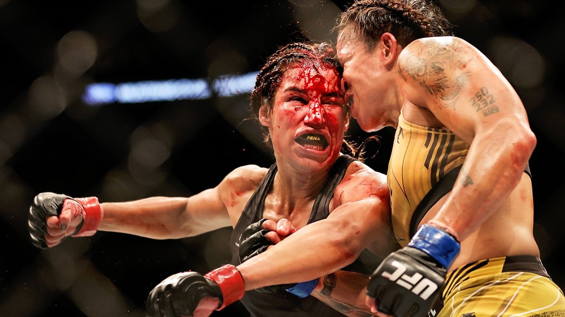 Amanda Nunes of Brazil exchanges strikes with Julianna Pena in their bantamweight title bout during UFC 277 