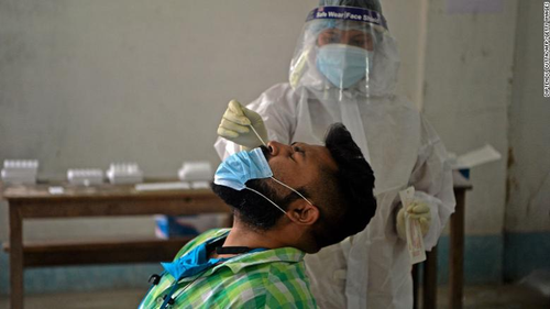 A health worker administers a COVID-19 test in Siliguri on April 30.