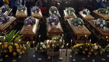 File - Coffins of 21 teenagers who died in a mysterious tragedy at a nightclub in the early hours of June 26, 2022 are lined up during their funeral held in Scenery Park, East London, South Africa, Wednesday, July 6, 2022. The toxic chemical methanol has been identified as a possible cause of the deaths of 21 teenagers at a bar in the South African city of East London last month, authorities said at press conference in East London Tuesday. July 19, 2022.  (AP Photo/File)