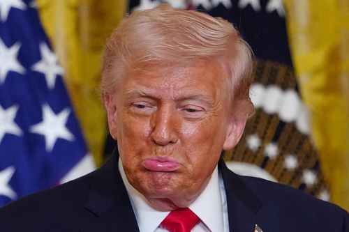President Donald Trump reacts after Olympic bobsledder Kaillie Humphries presented him with the Order of Ikkos medal at a women's history month event in the East Room at the White House, Thursday, March 12, 2026, in Washington.