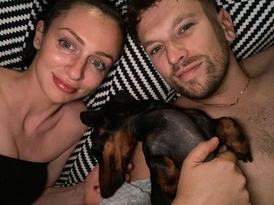 Dylan Alcott in bed with his girlfriend, Chantelle Otten, and their dog Sauce.
