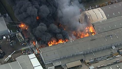 A massive fire has engulfed a factory in Revesby. (9NEWS)