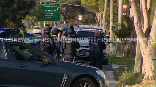 Armed police surrounded the home. (9NEWS)