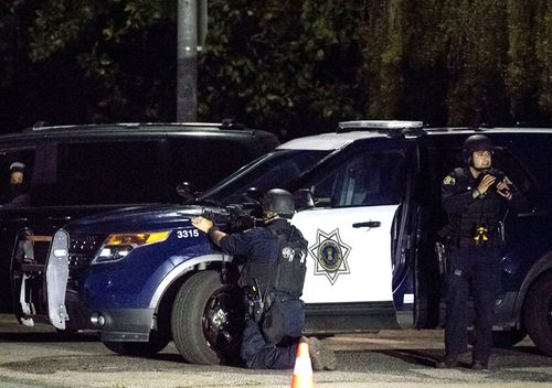 Police stay focused on a target after a deadly shooting at the Gilroy Garlic Festival in Gilroy, California.