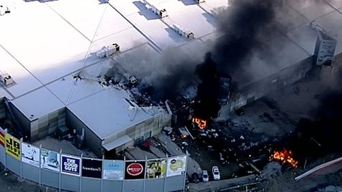 Five people are believed to have been on board a charter plane that crashed in a Melbourne direct factory outlet and exploded.