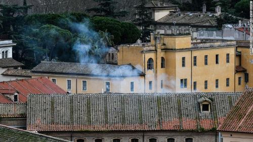 Smoke billows from a rooftop of the Regina Coeli prison in central Rome after protests in at least 22 prisons left 11 inmates dead.