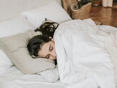 Stock photo of a woman in bed.