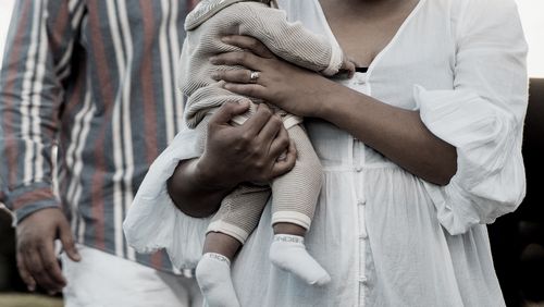 Happy couple enjoying outdoor with their small child.