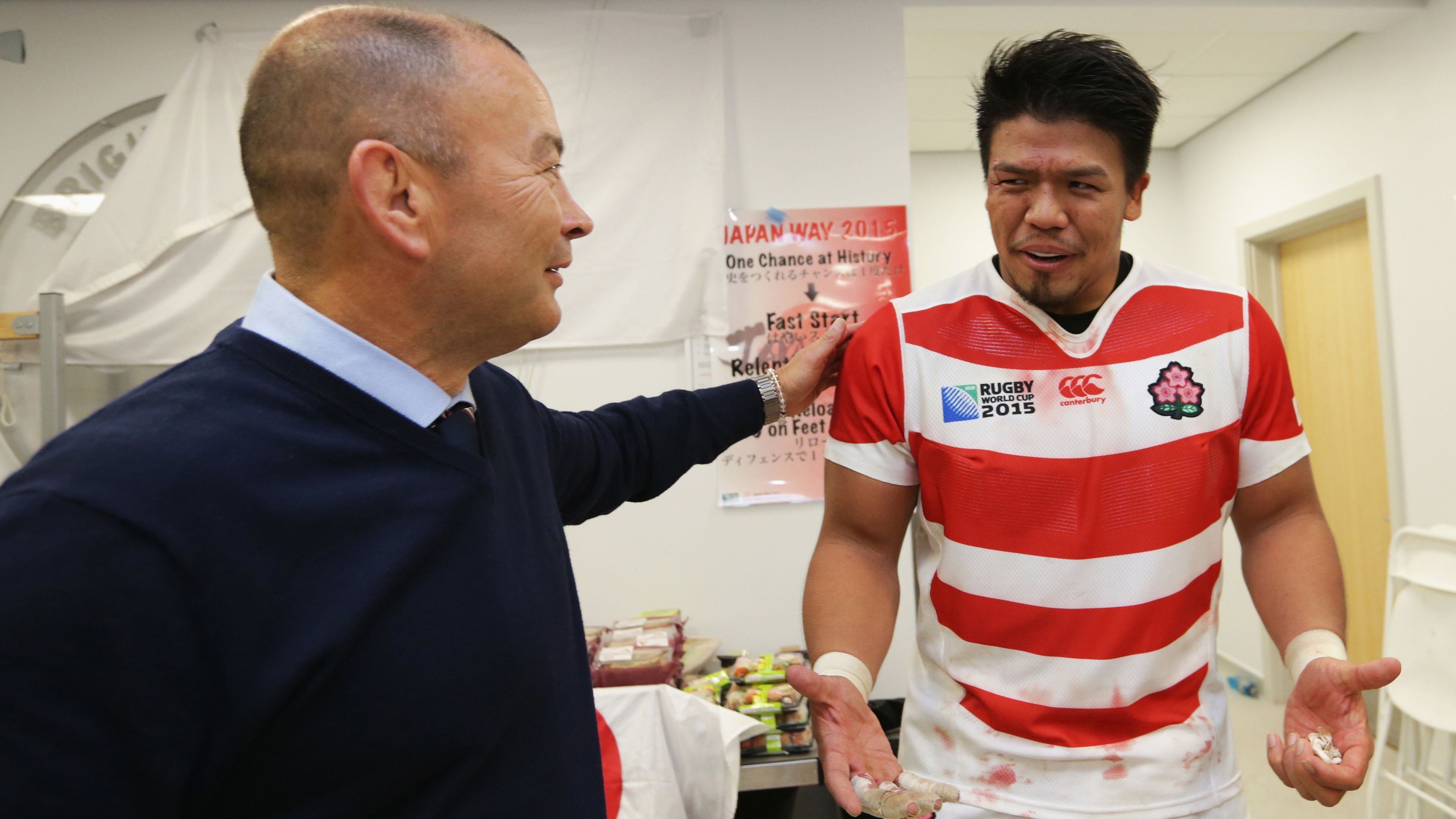 Japan coach Eddie Jones congratulates Takeshi Kizu following their surprise victory over South Africa at the 2015 Rugby World Cup.