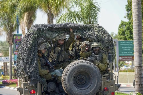 Israeli soldiers are seen in the southern Israeli city of Sderot, Saturday, Oct. 7, 2023.  