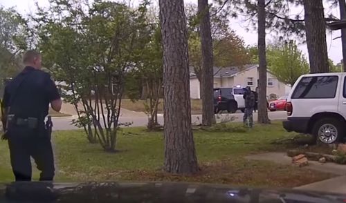 An officer can be seen approaching the home when the massive explosion occurs.