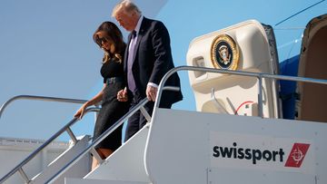 US President Donald Trump disembarks a plane with first lady Melania Trump. (AAP)