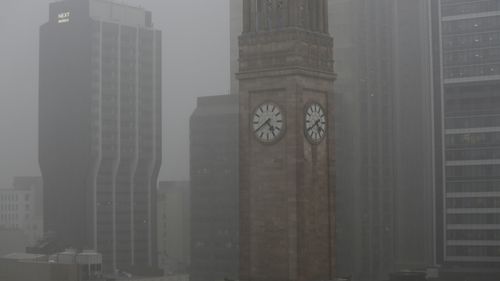 eavy rain hits Brisbane CBD as storms sweep across south-east Queensland. 