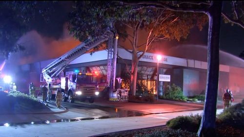 Fire crews have spent the night battling a fire across two factories in Cheltenham.